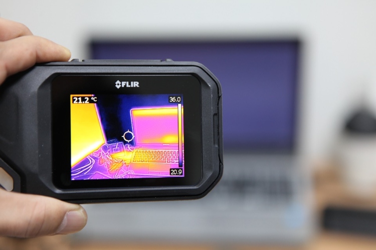 A camera showing a thermal image of a laptop.