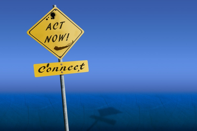 A yellow sign that reads “act now!” over a blue background.